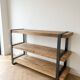 Industrial bookshelf console in solid wood and steel.