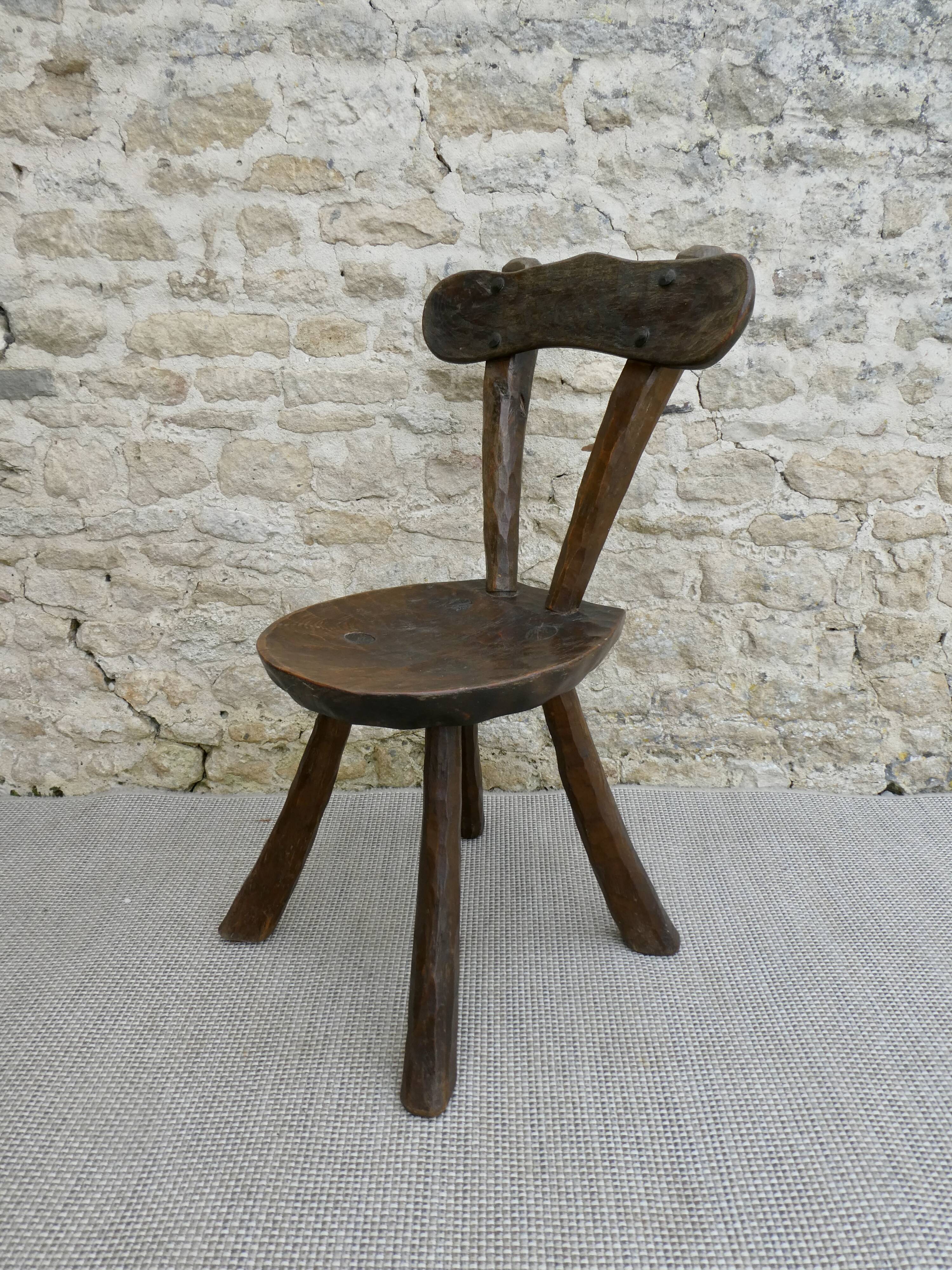 Brutalist chair in carved solid wood, around 1950.
