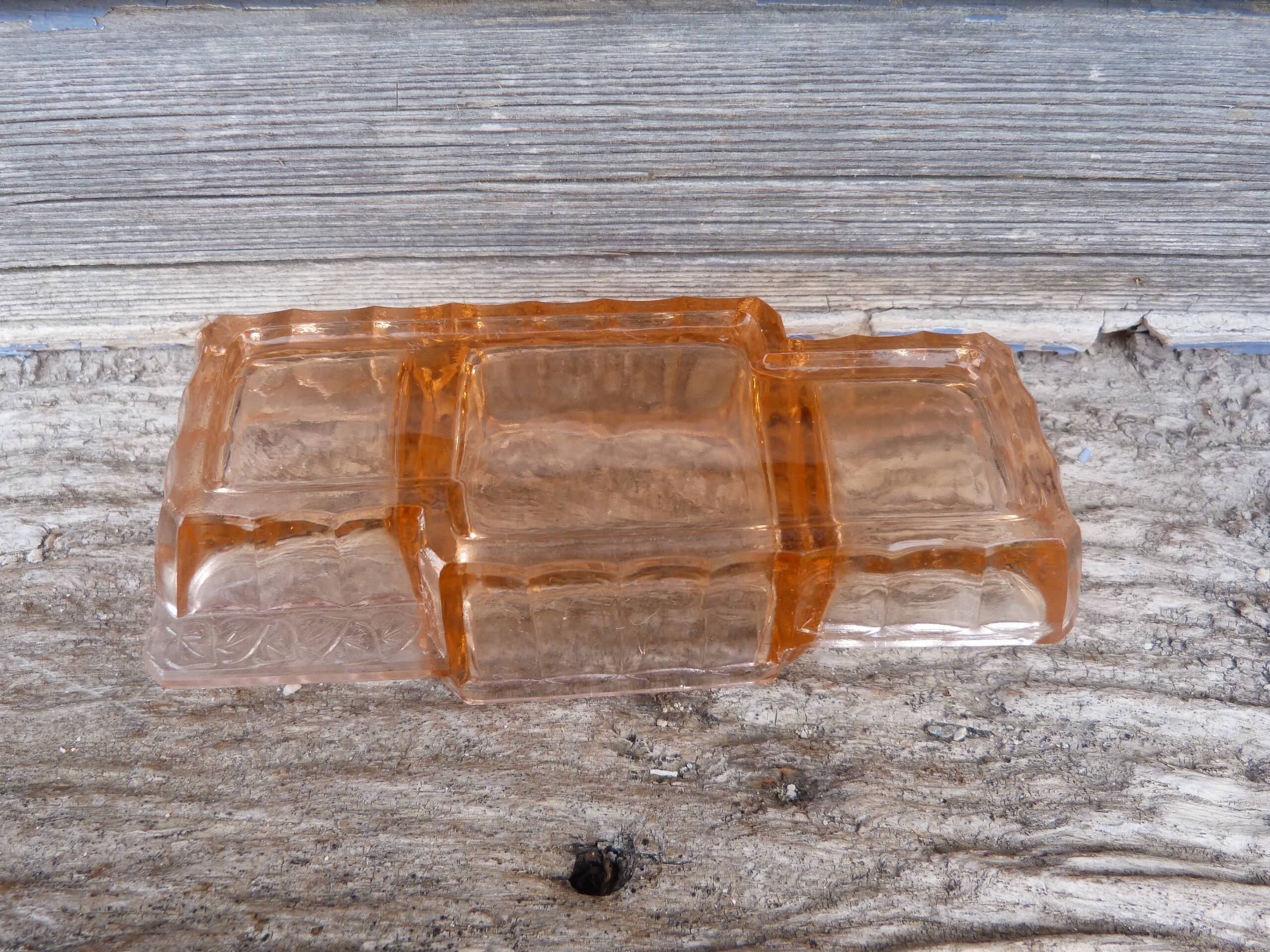 Glass condiment service in transparent pink moulded glass.