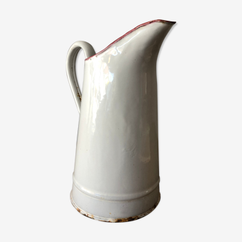 Old pitcher in enamelled sheet metal