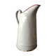 Old pitcher in enamelled sheet metal