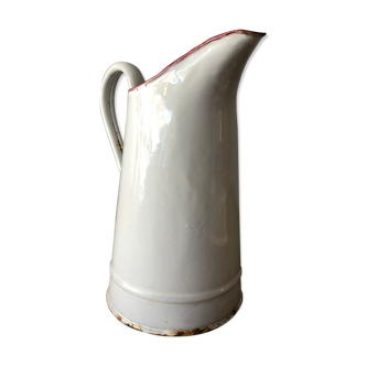 Old pitcher in enamelled sheet metal