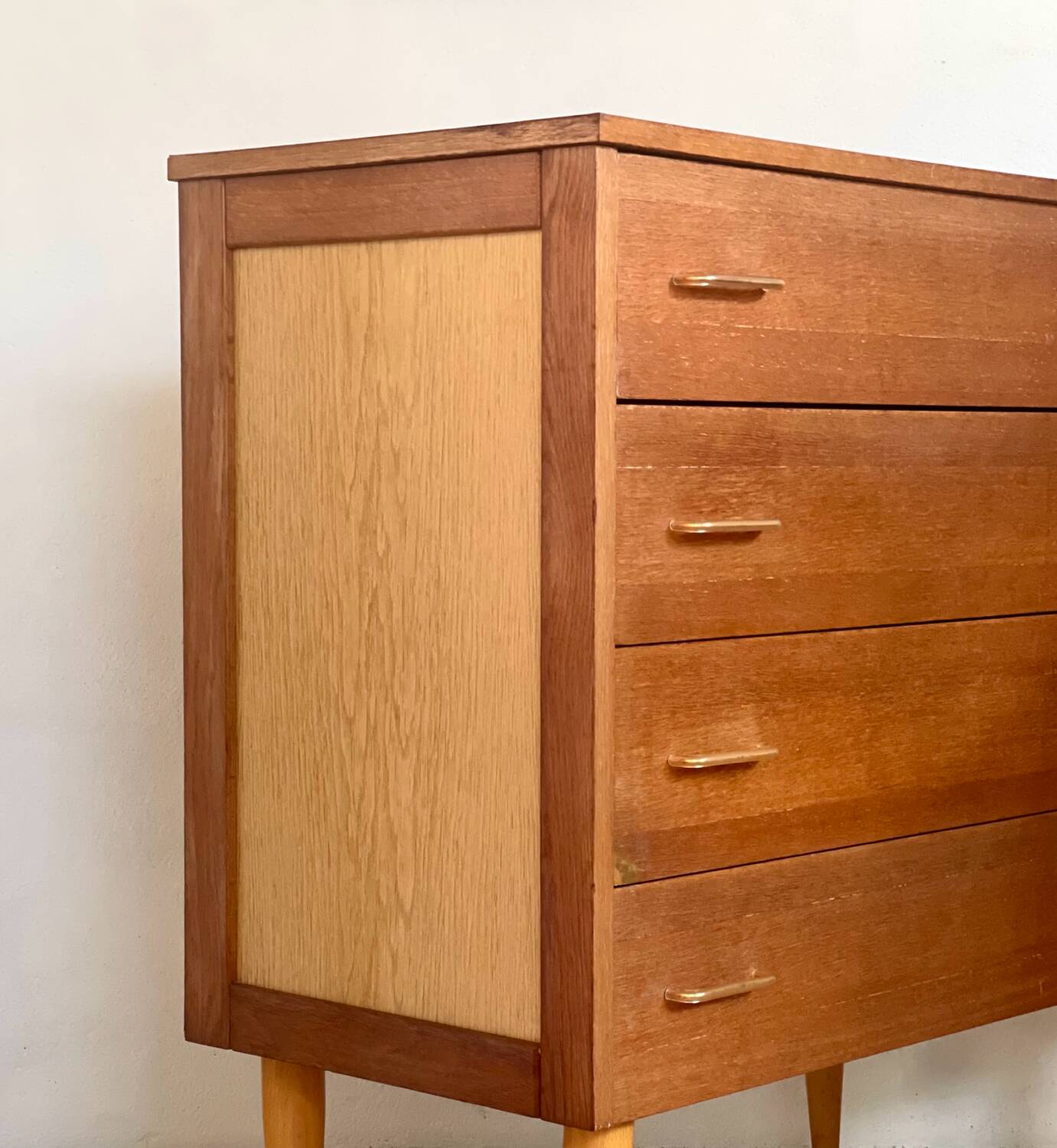 Vintage 1960s chest of drawers with covered handles.