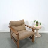 Brown-grey armchair with an oak frame.