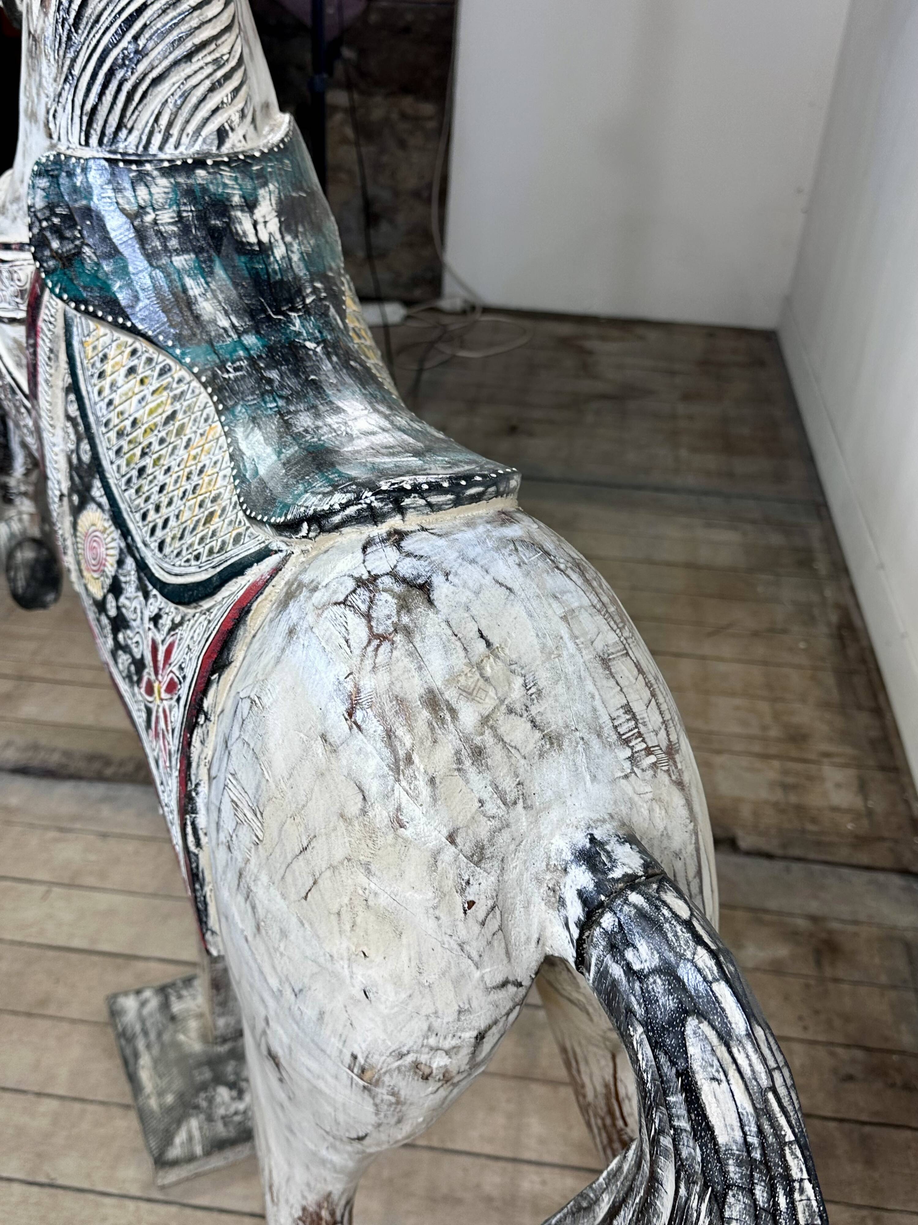 Carved and patinated wooden carousel horse
