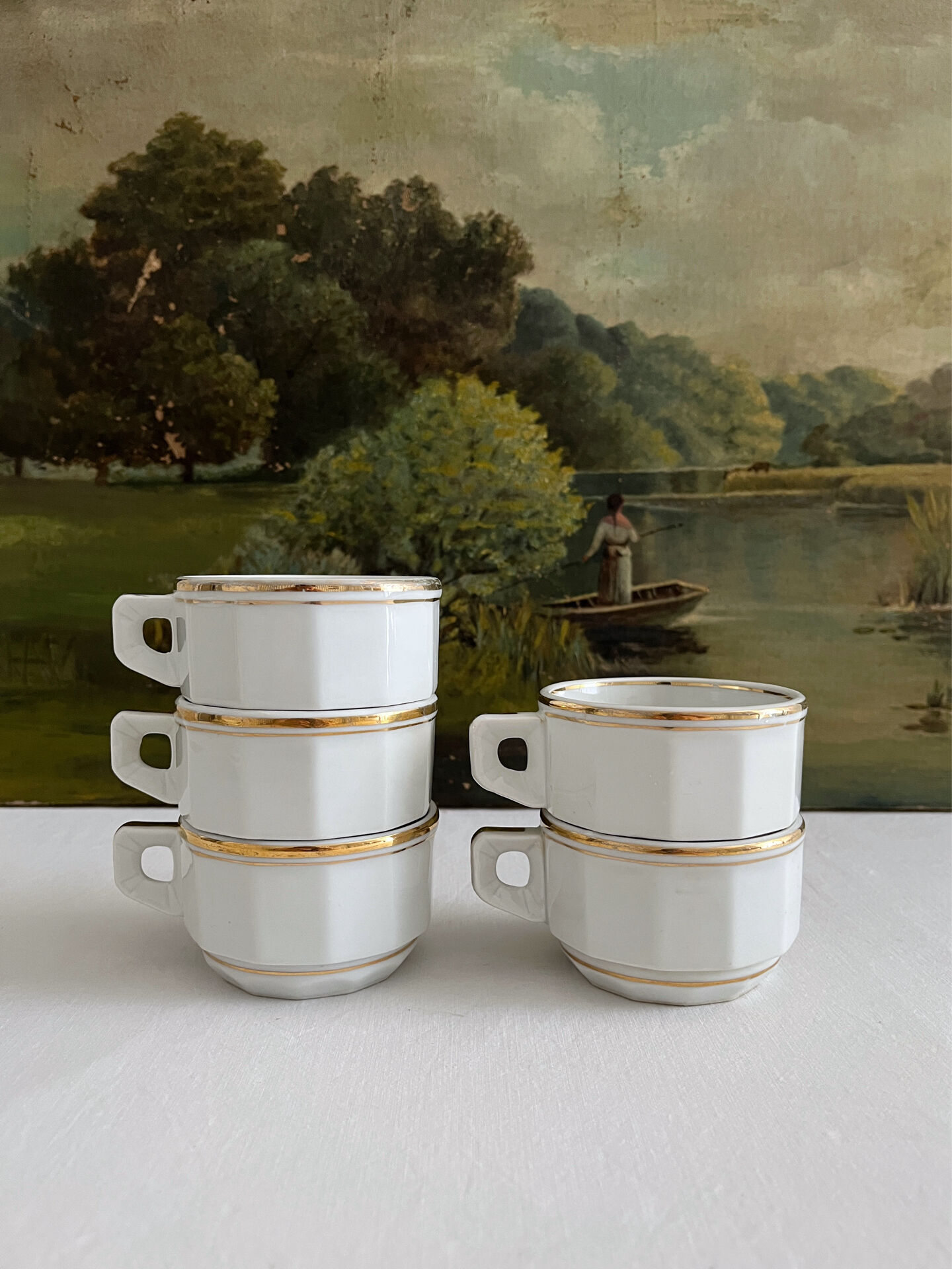 5 vintage porcelain bistro coffee cups from Paris with gold trim.
