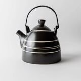 Vintage ceramic teapot from the 1980s, black with white stripes and a metal handle.