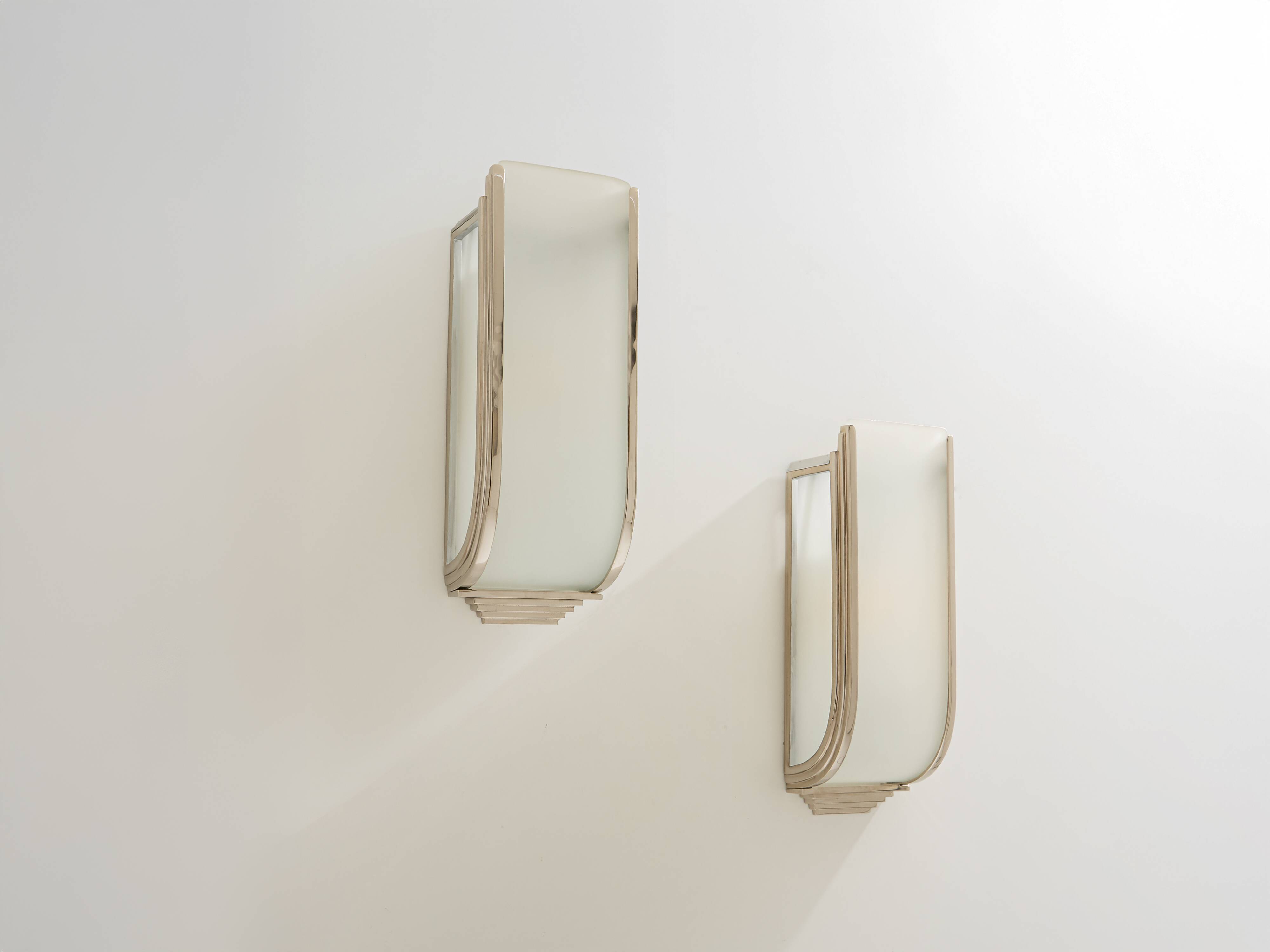 Pair of modernist wall sconces in nickel-plated steel and opaline glass, 1930.