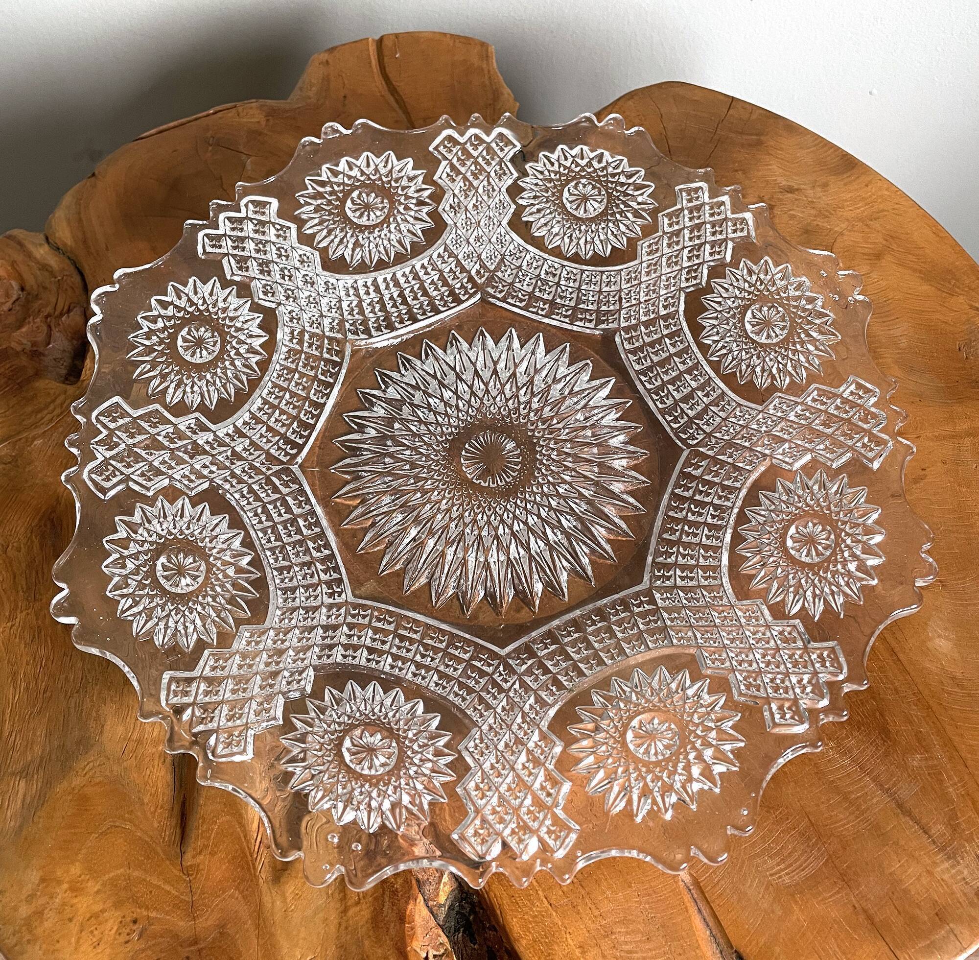 Vintage pressed glass plate with rosette design, octagonal rim, star pattern reminiscent of mandala