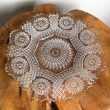 Vintage pressed glass plate with rosette design, octagonal rim, star pattern reminiscent of mandala