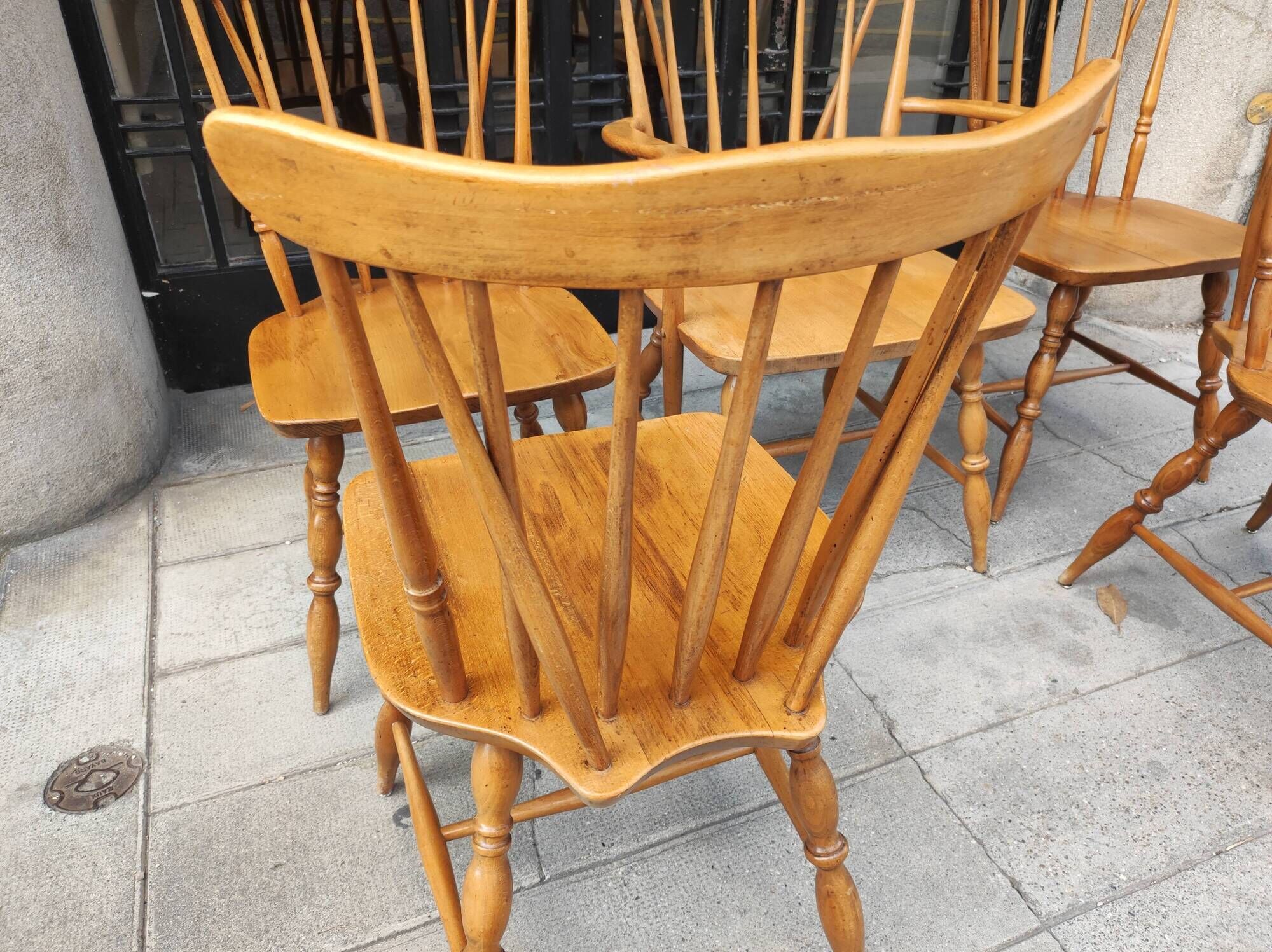Four chairs and a Heywood Wakefield Windsor armchair. Vintage