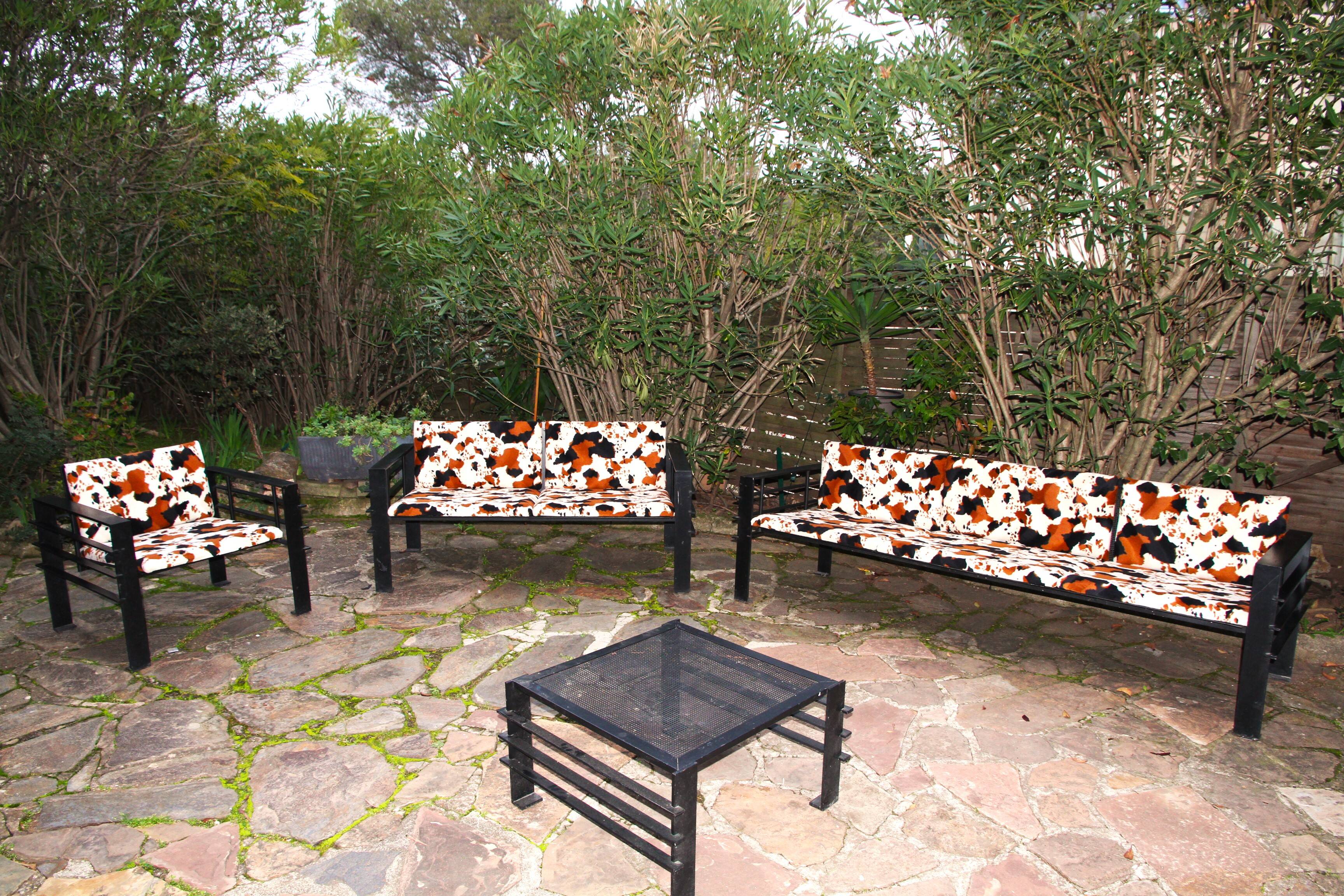 Set of sofas, armchair and coffee table in wrought iron by Jean Michel Wilmotte.