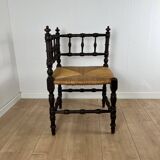 Corner chair in carved wood and straw, late 19th century.