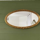 Miroir mural ovale doré