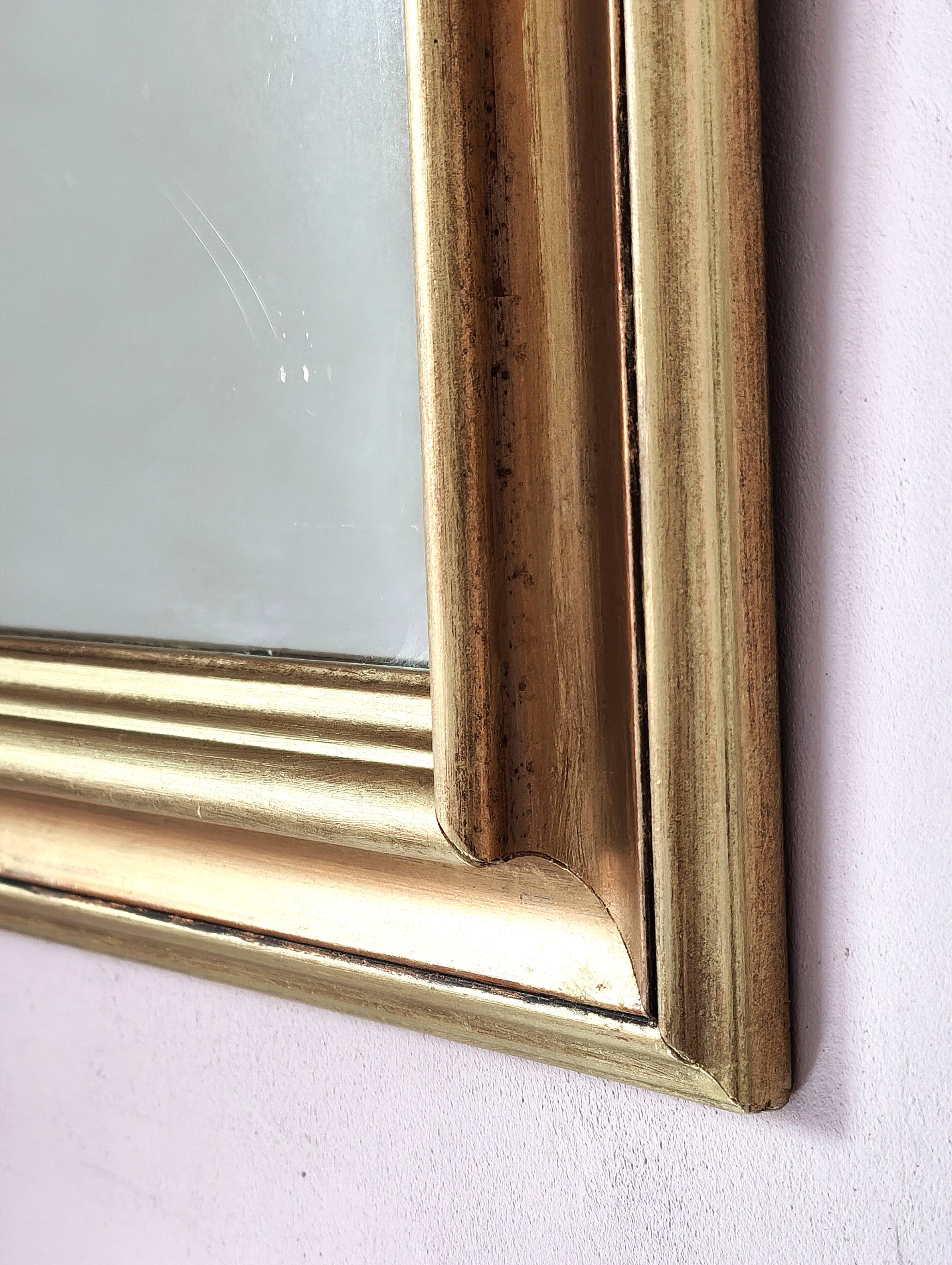 Miroir ancien en bois doré et cuivré