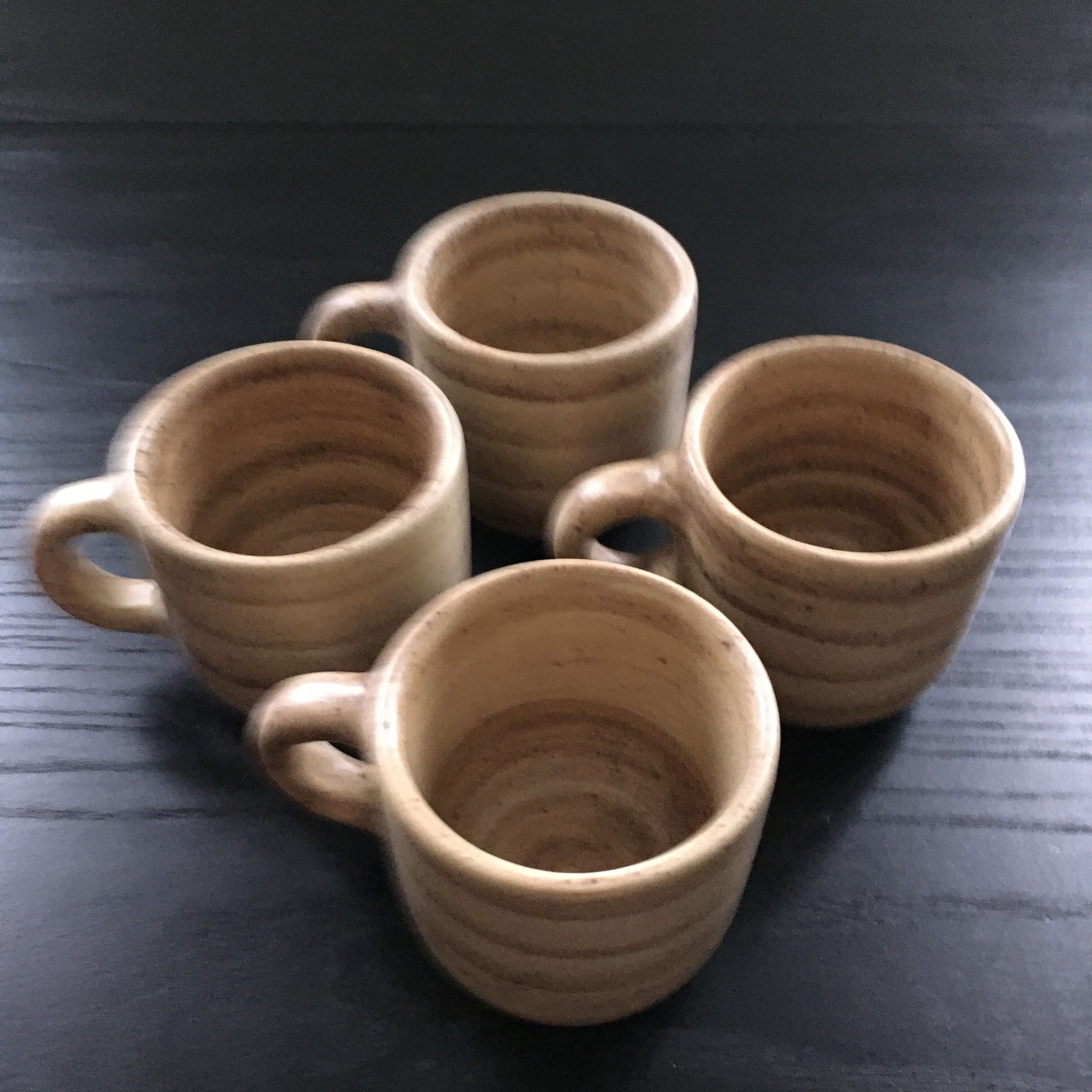 Set of 4 beige stoneware mugs.