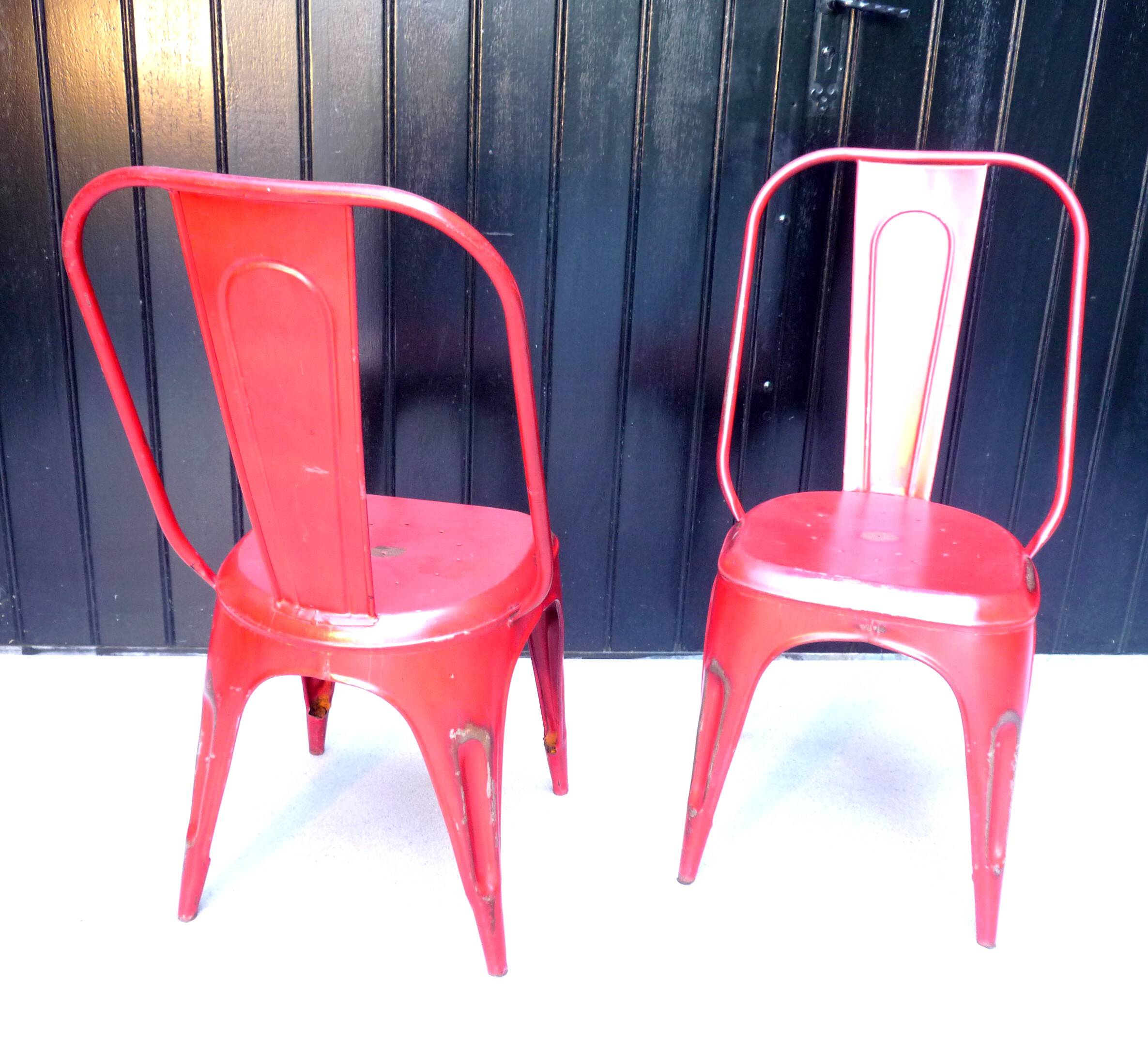 Pair of red stackable metal chairs