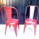 Pair of red stackable metal chairs