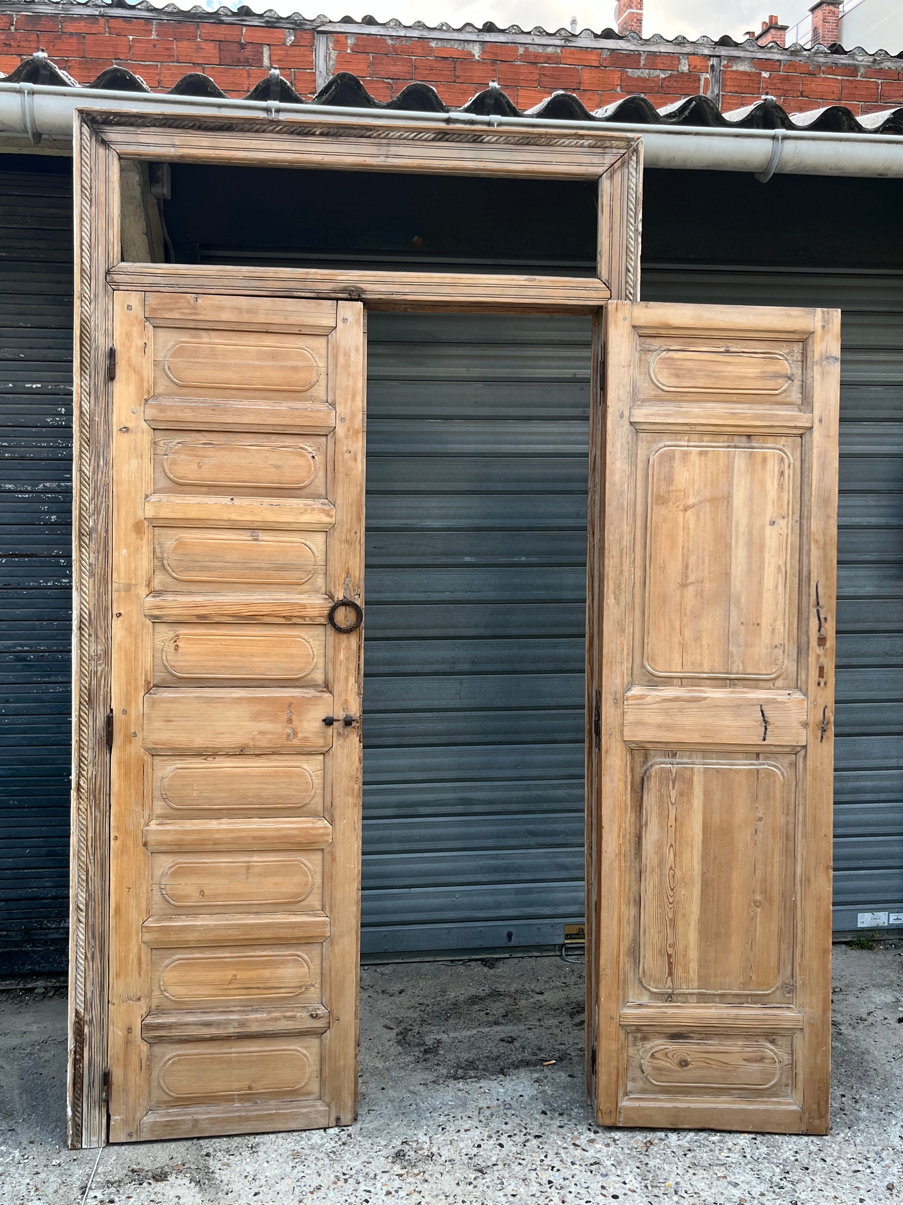 pair of old double-leaf doors with transom and carved frames