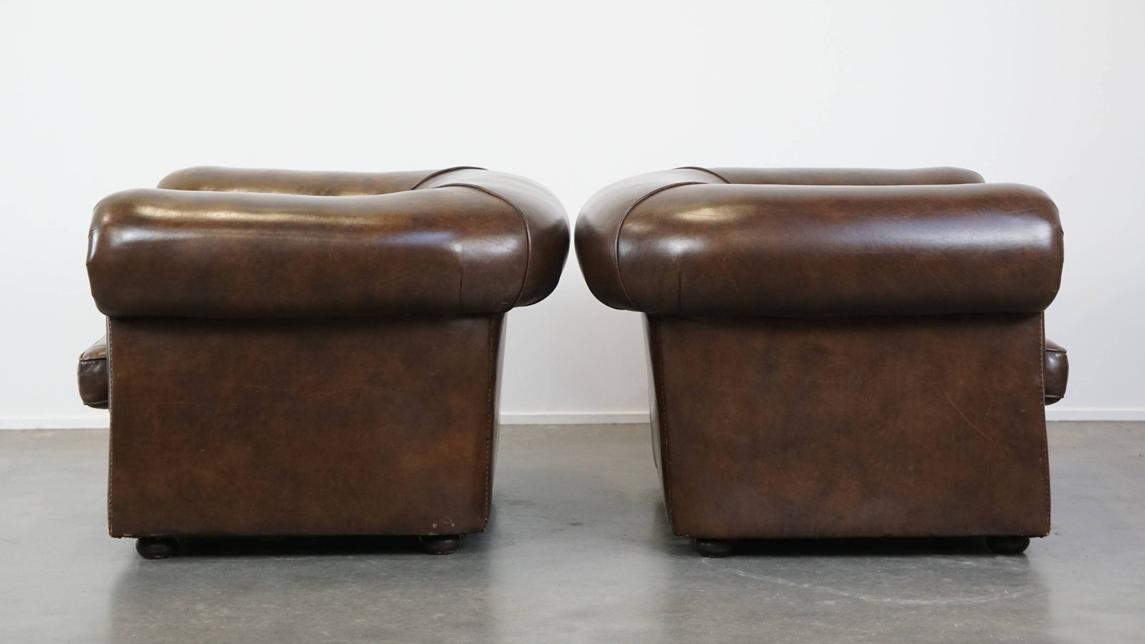 2 Chesterfield armchairs in dark brown cowhide