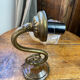 Bronze and glass wall light in the shape of a flower.