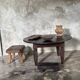 Antique round coffee table in Indonesian teak with turned legs.