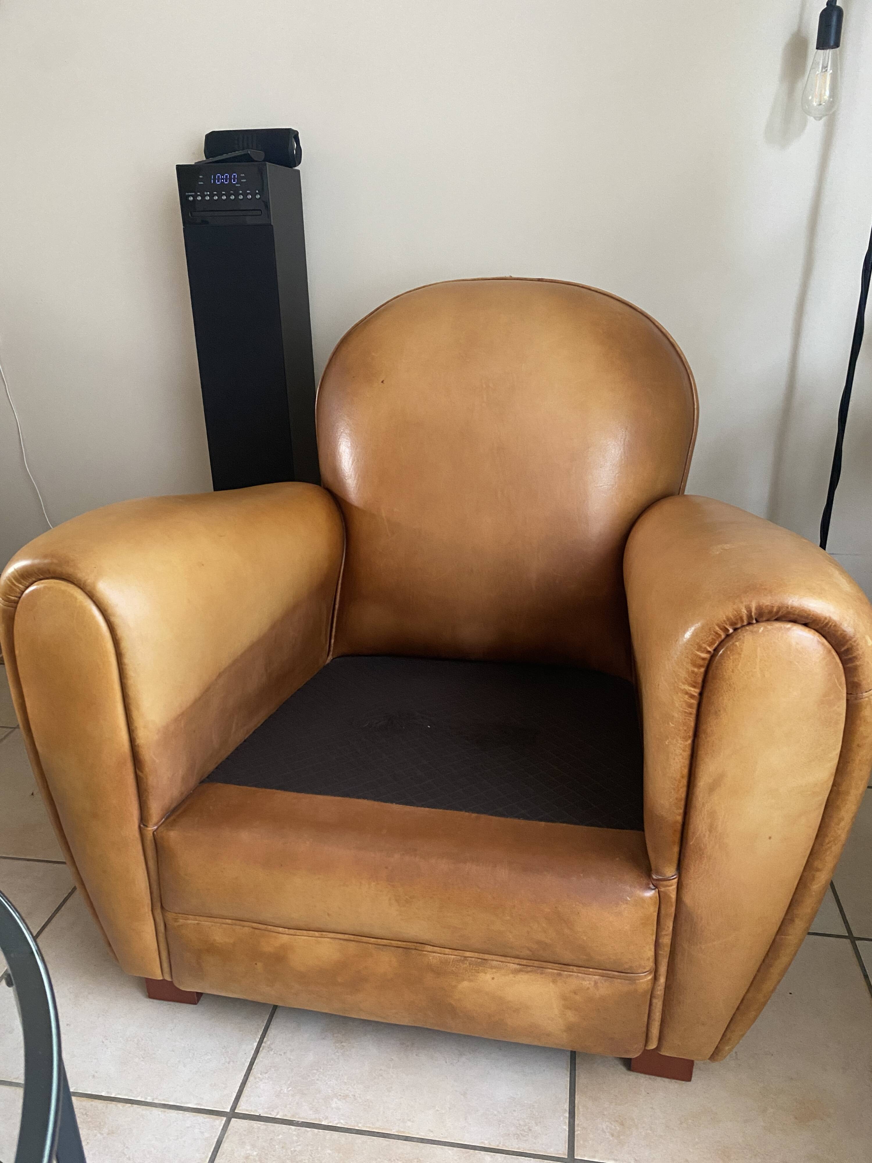 Brown leather club armchairs with an antique finish.