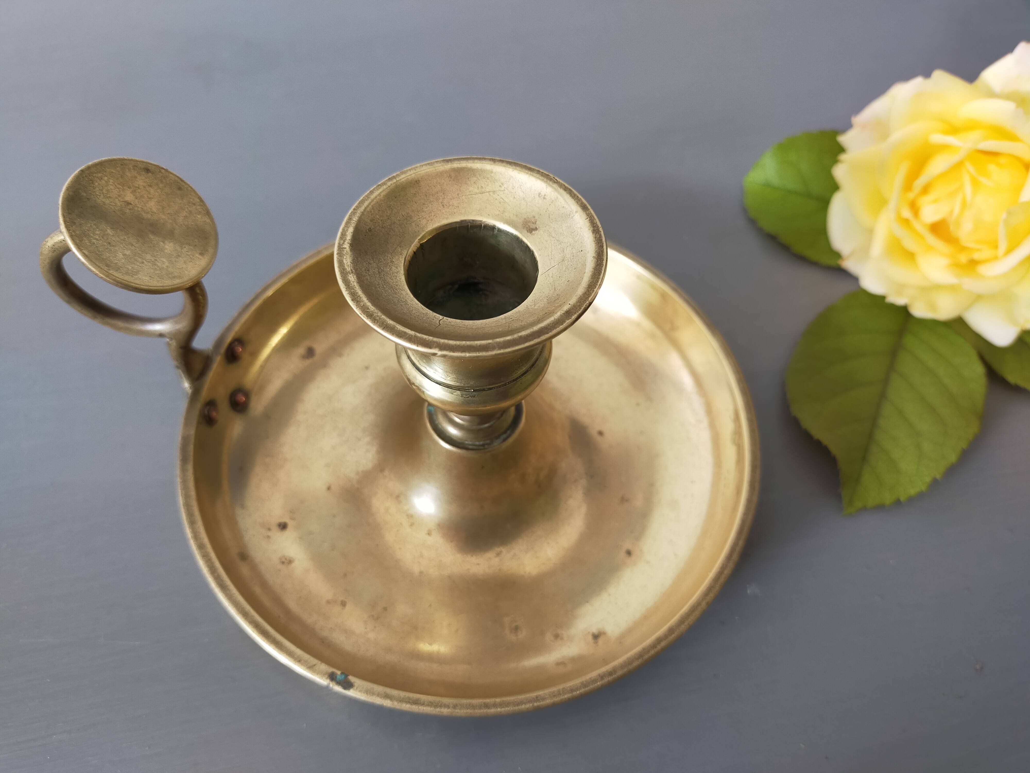 brass candle holder with old cellar rat thumb