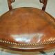19th century armchair in leather and rosewood inlaid with brass and rosewood
