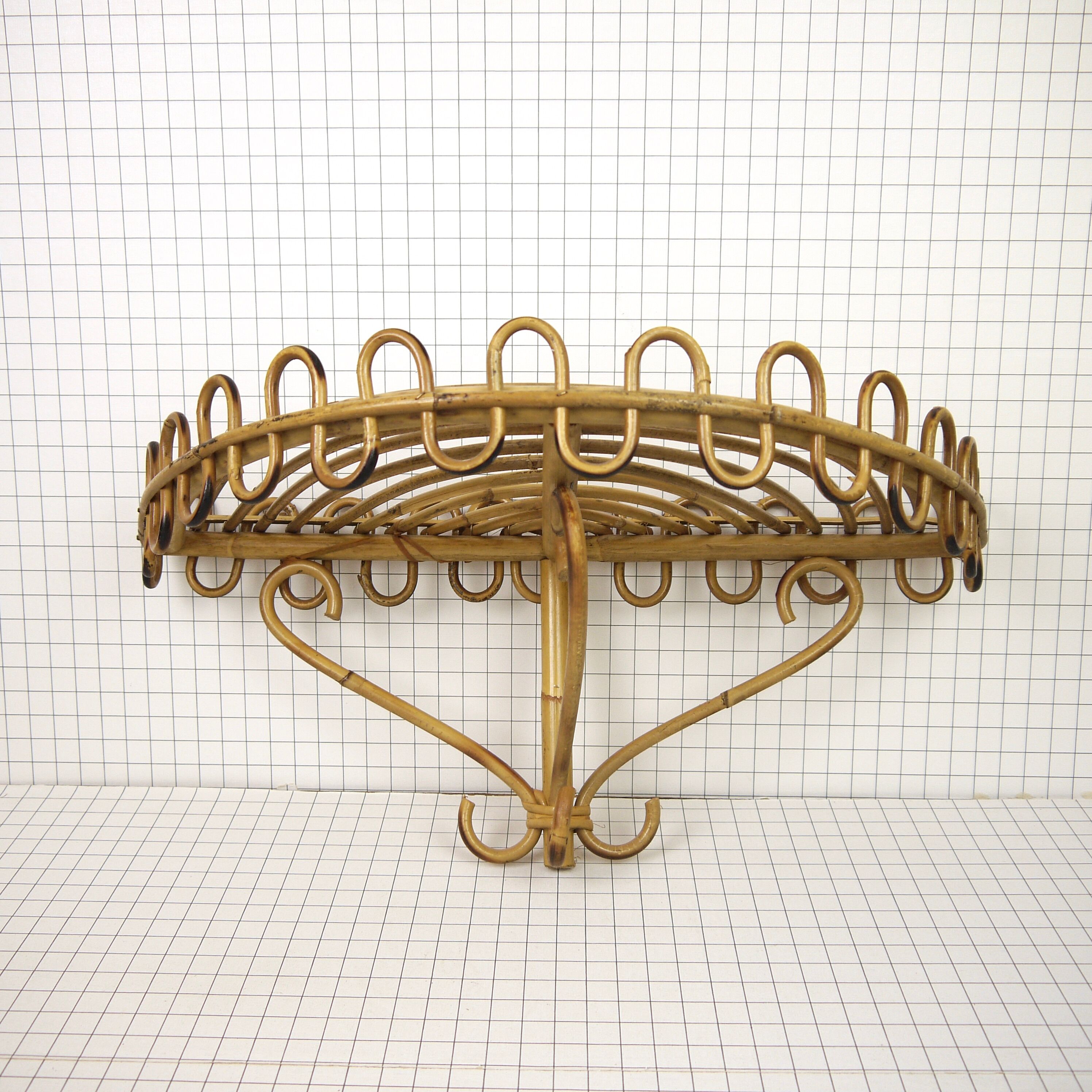 Half-moon rattan shelf and coat holder