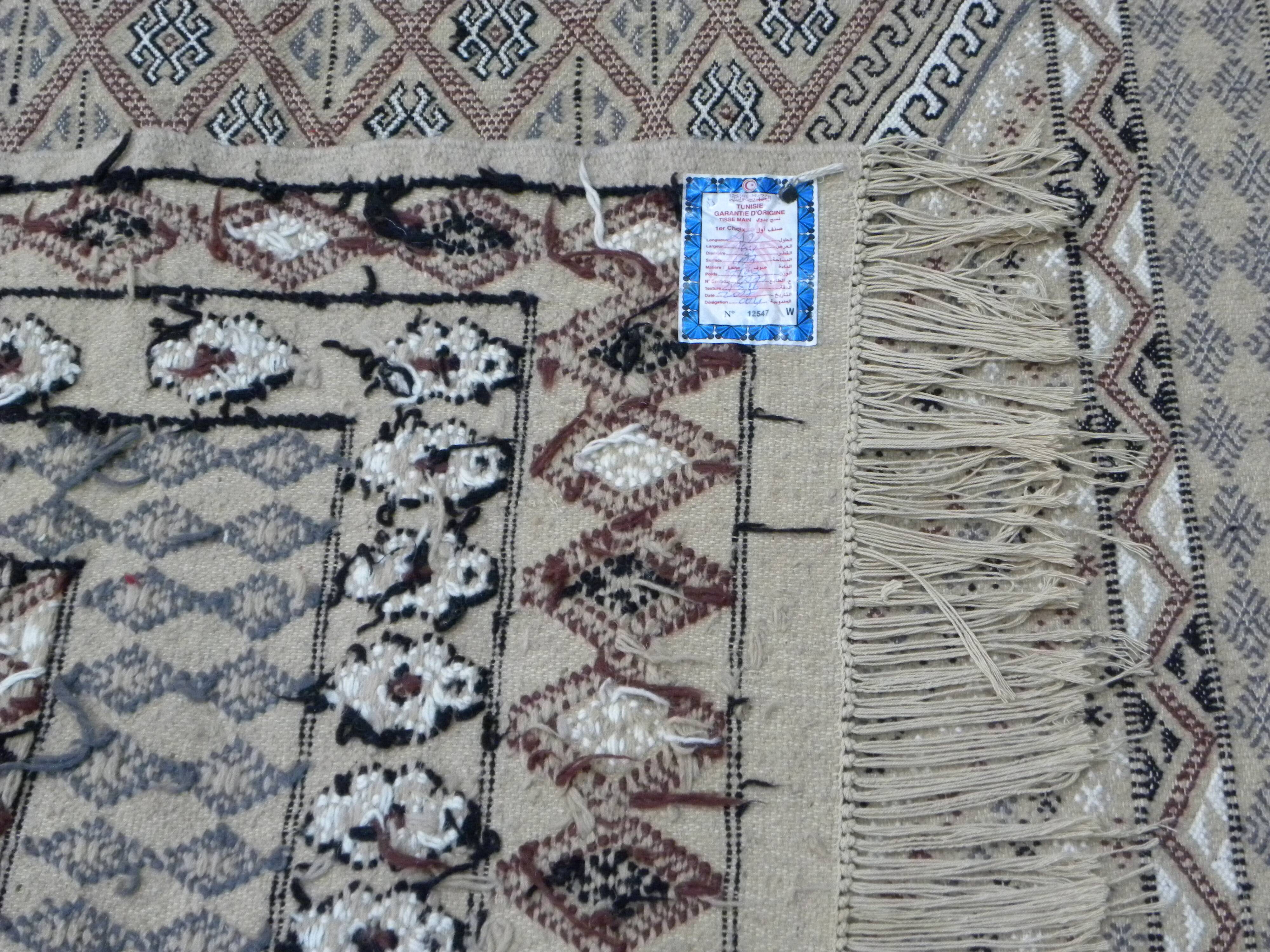Traditional handmade Berber carpet in brown and beige wool.