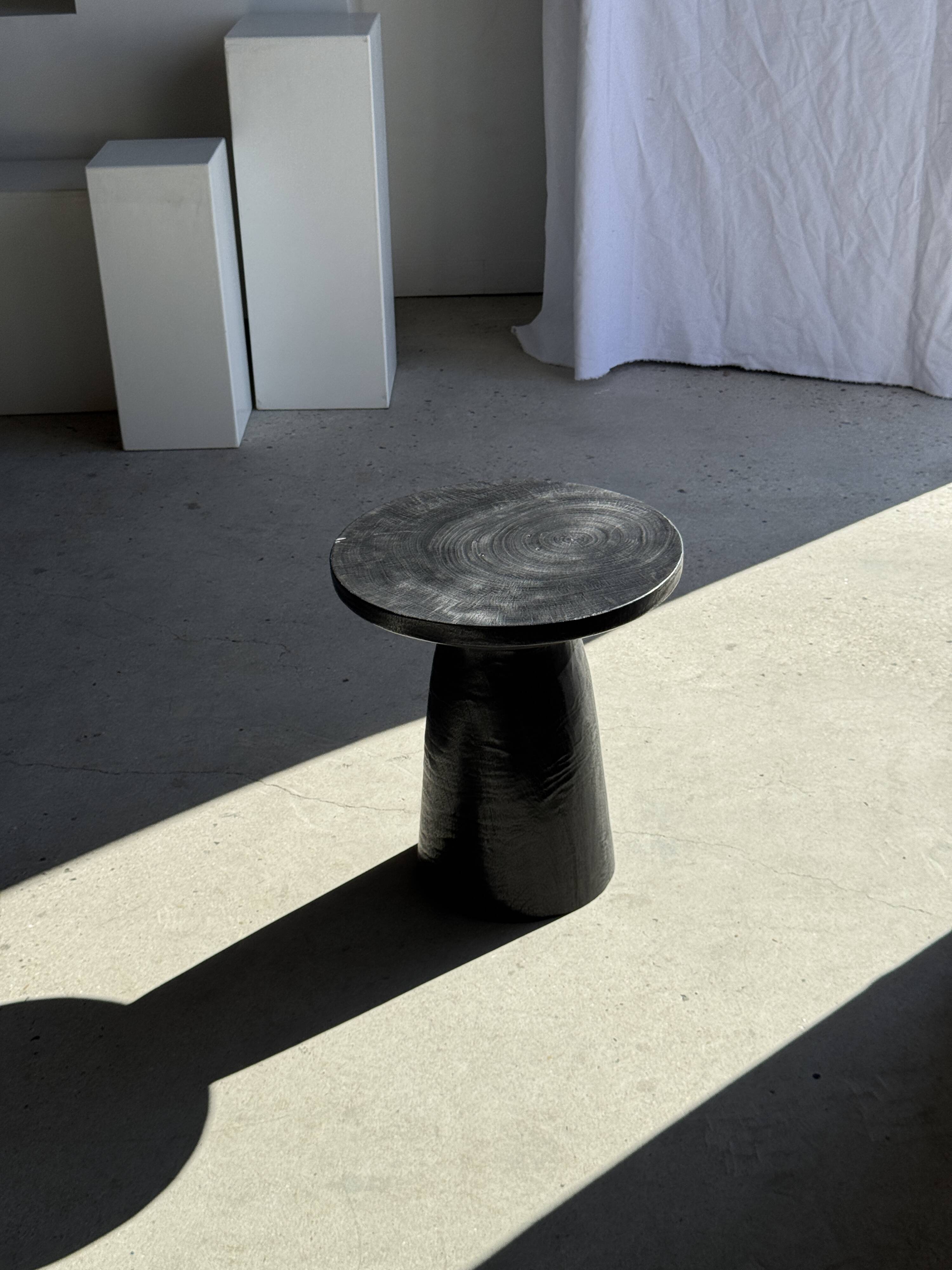 Black solid mango side table (monoxyle) with conical legs