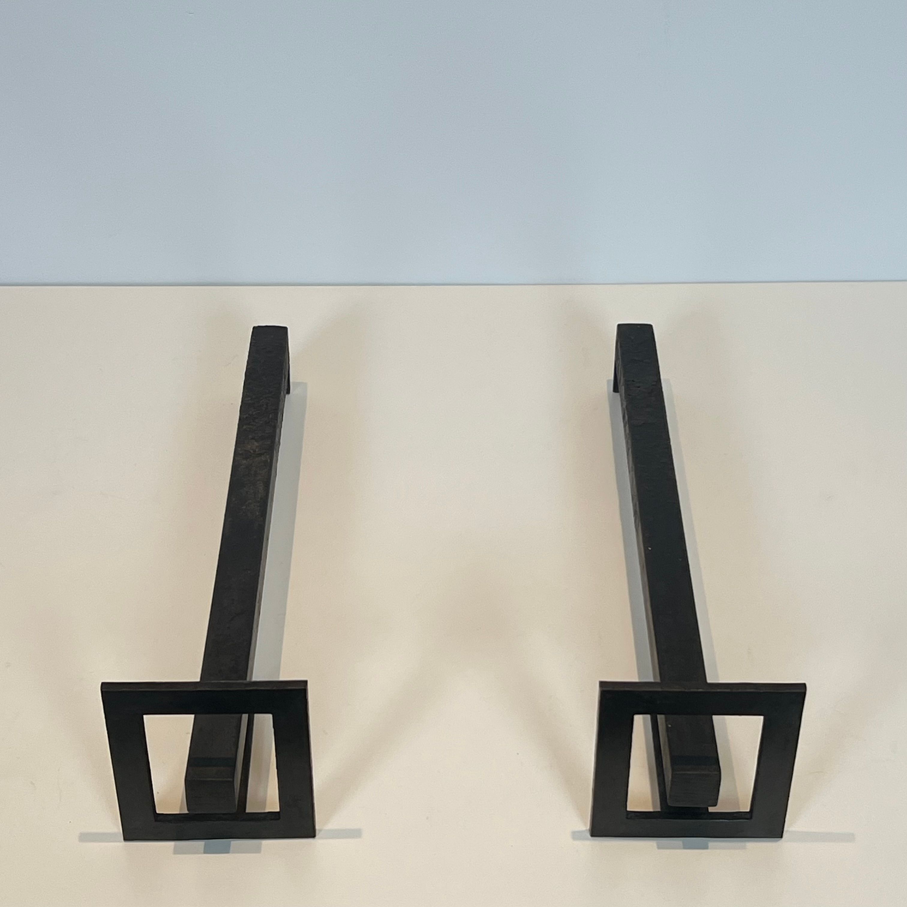 Pair of modernist andirons in steel and wrought iron