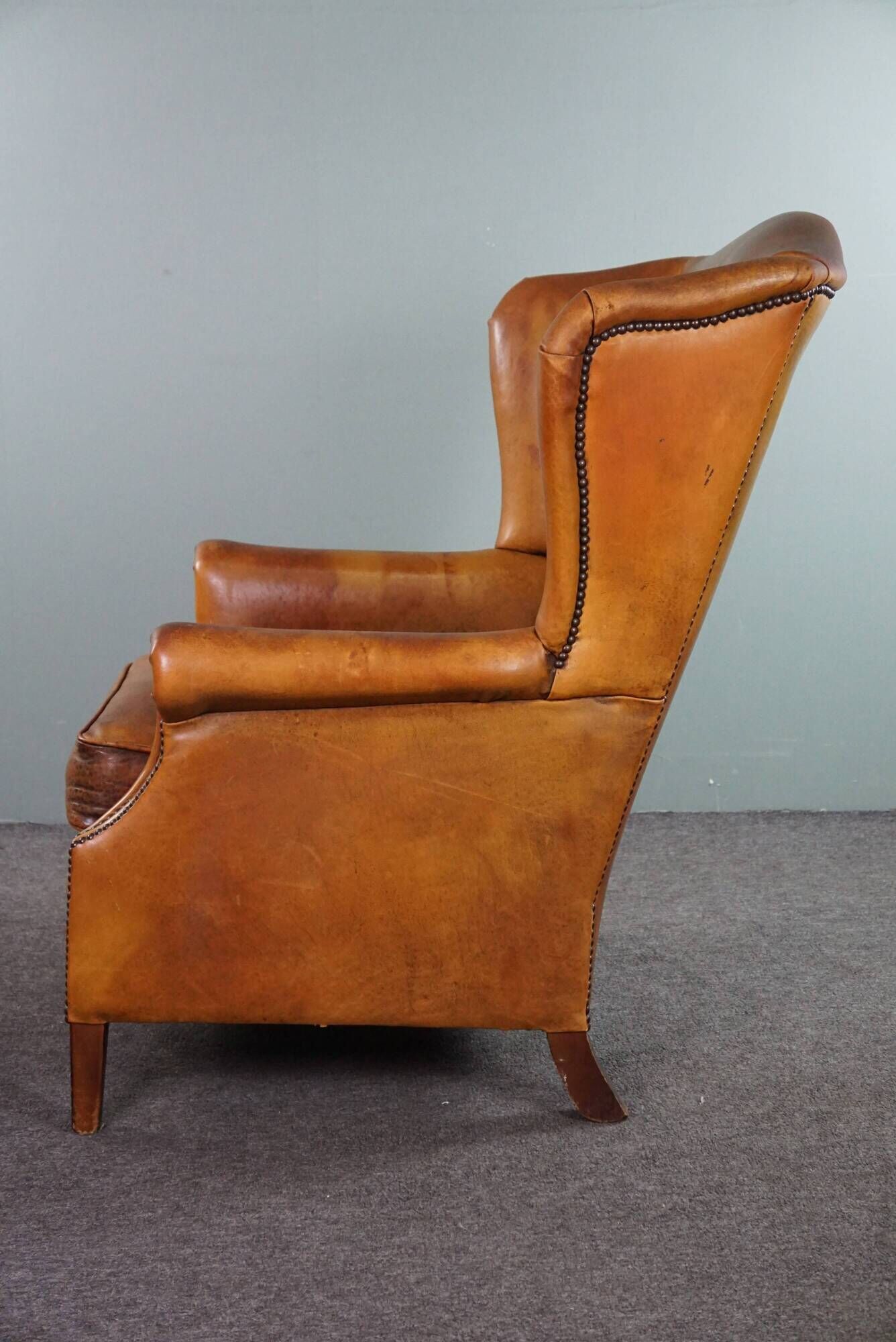 Wingback chair made of sheepskin leather in a light honey color