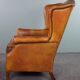 Wingback chair made of sheepskin leather in a light honey color