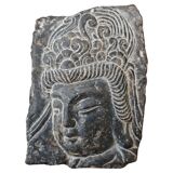 Antique portrait of Buddha hand-carved in stone, 19th century.