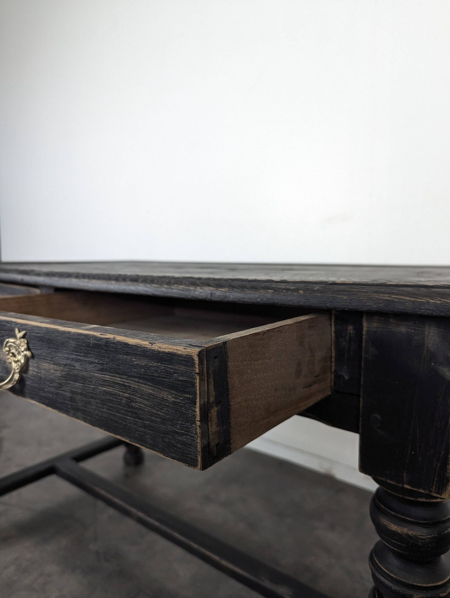 Louis XIII style desk in blackened wood with turned legs and two drawers.