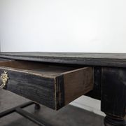 Louis XIII style desk in blackened wood with turned legs and two drawers.