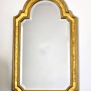 Florentine arched mirror in gilded wood with gold leaf.