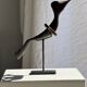 Traditional Indonesian decorative wooden bird on a base, crest model.