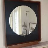 Scandinavian mirror with wooden frame and backlighting.