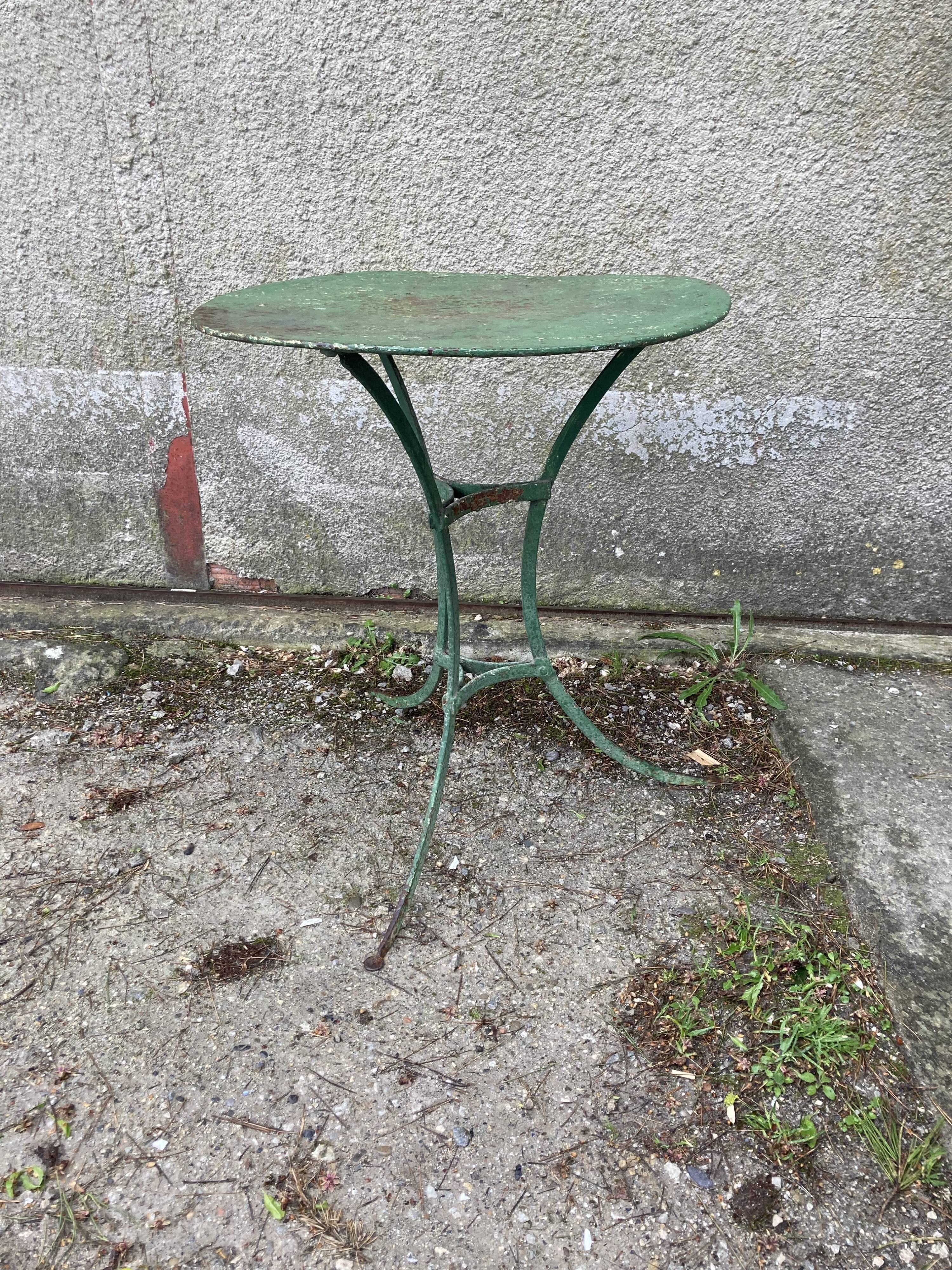 Riveted green old garden pedestal table
