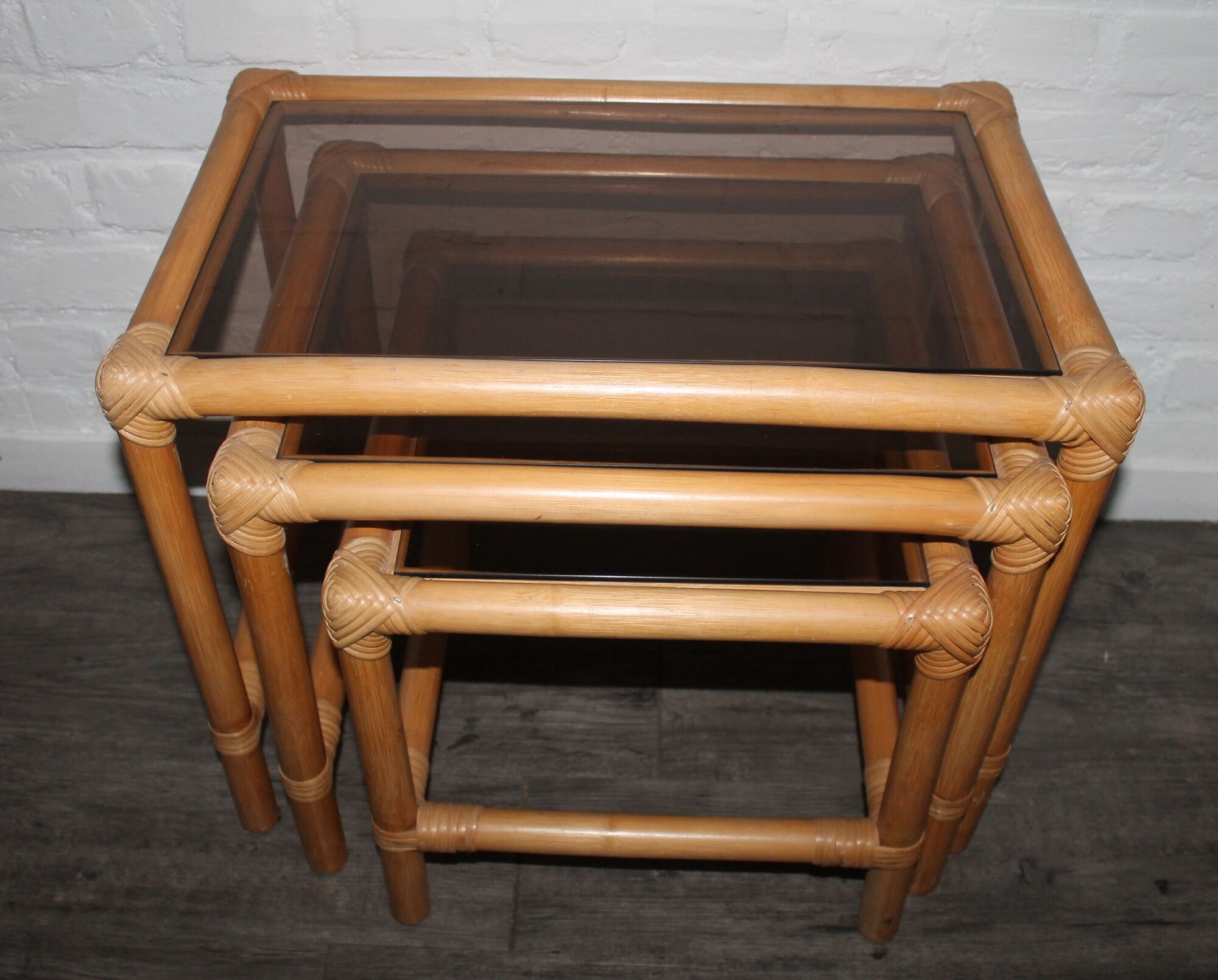 Rattan nesting tables in rattan and smoked glass from the 70s