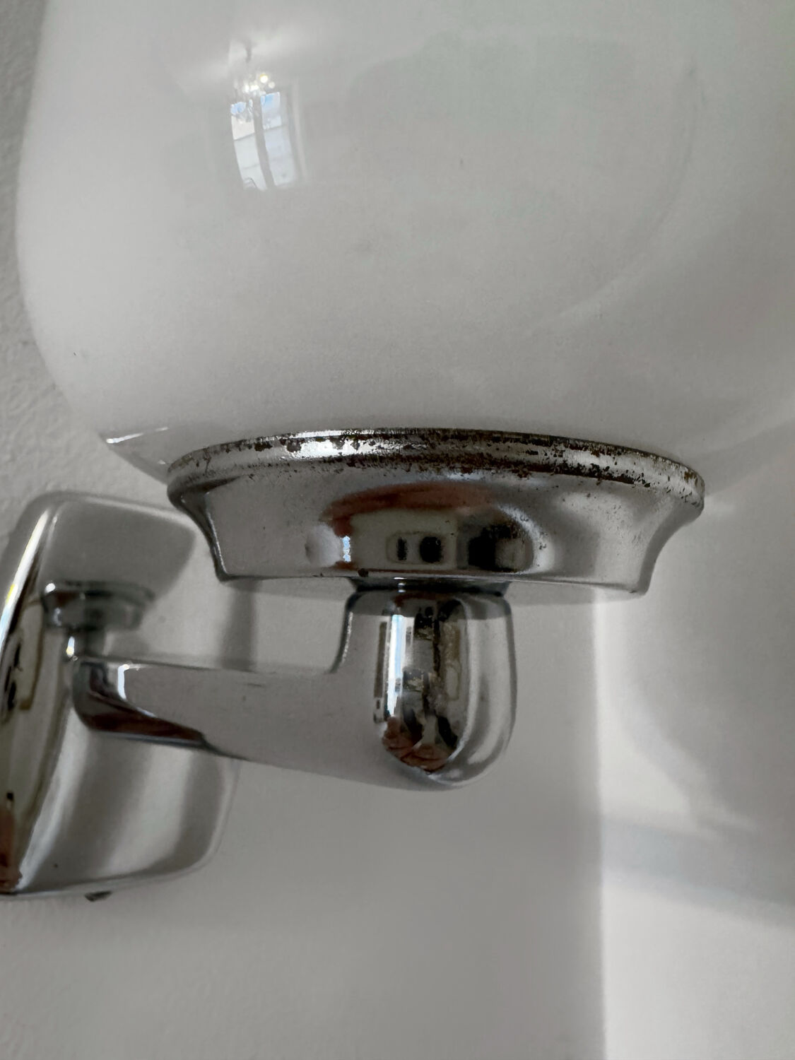 Chrome and opaline wall lights from the 70s.