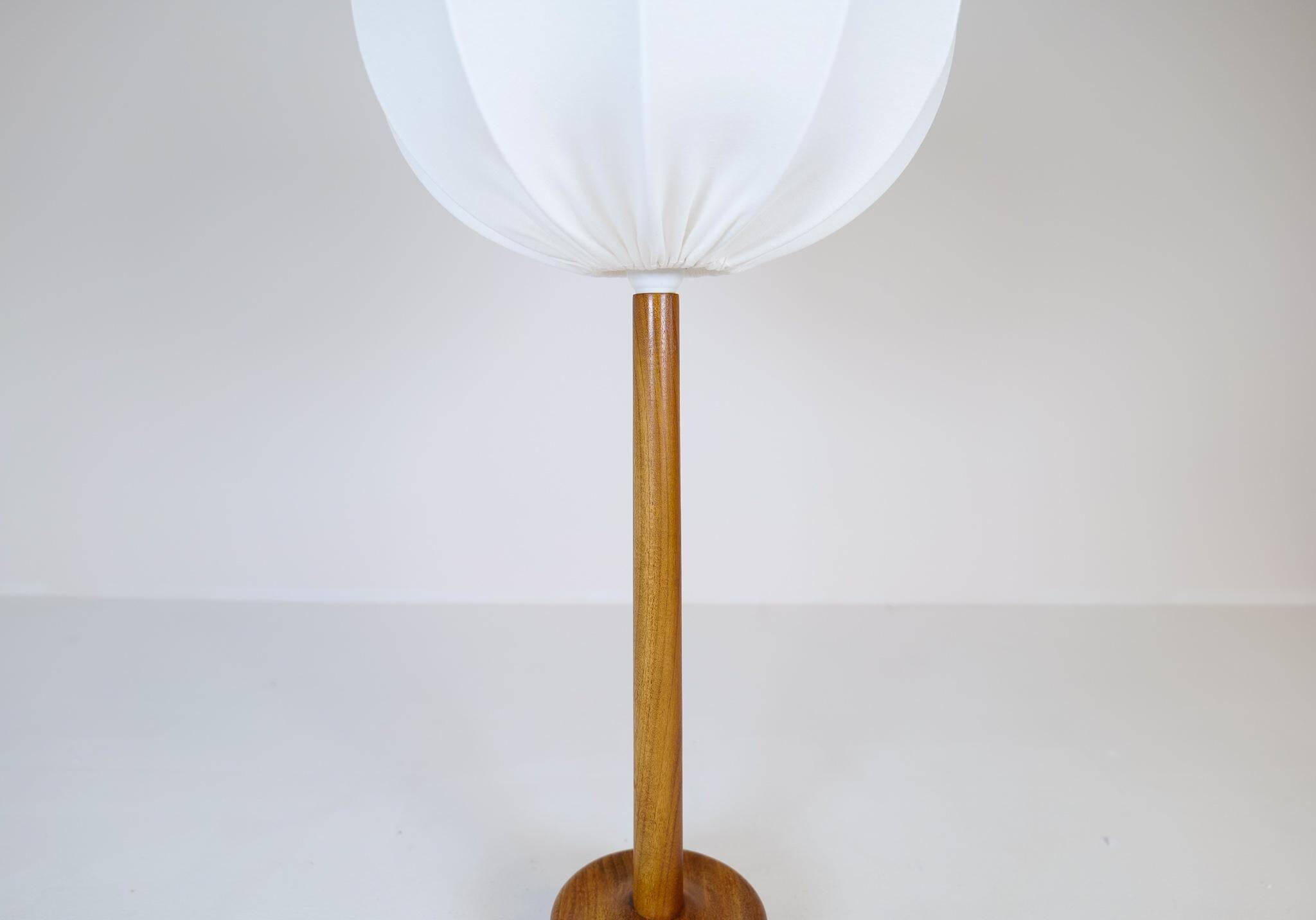 Mid-century solid teak table lamp from the 1960s Sweden.