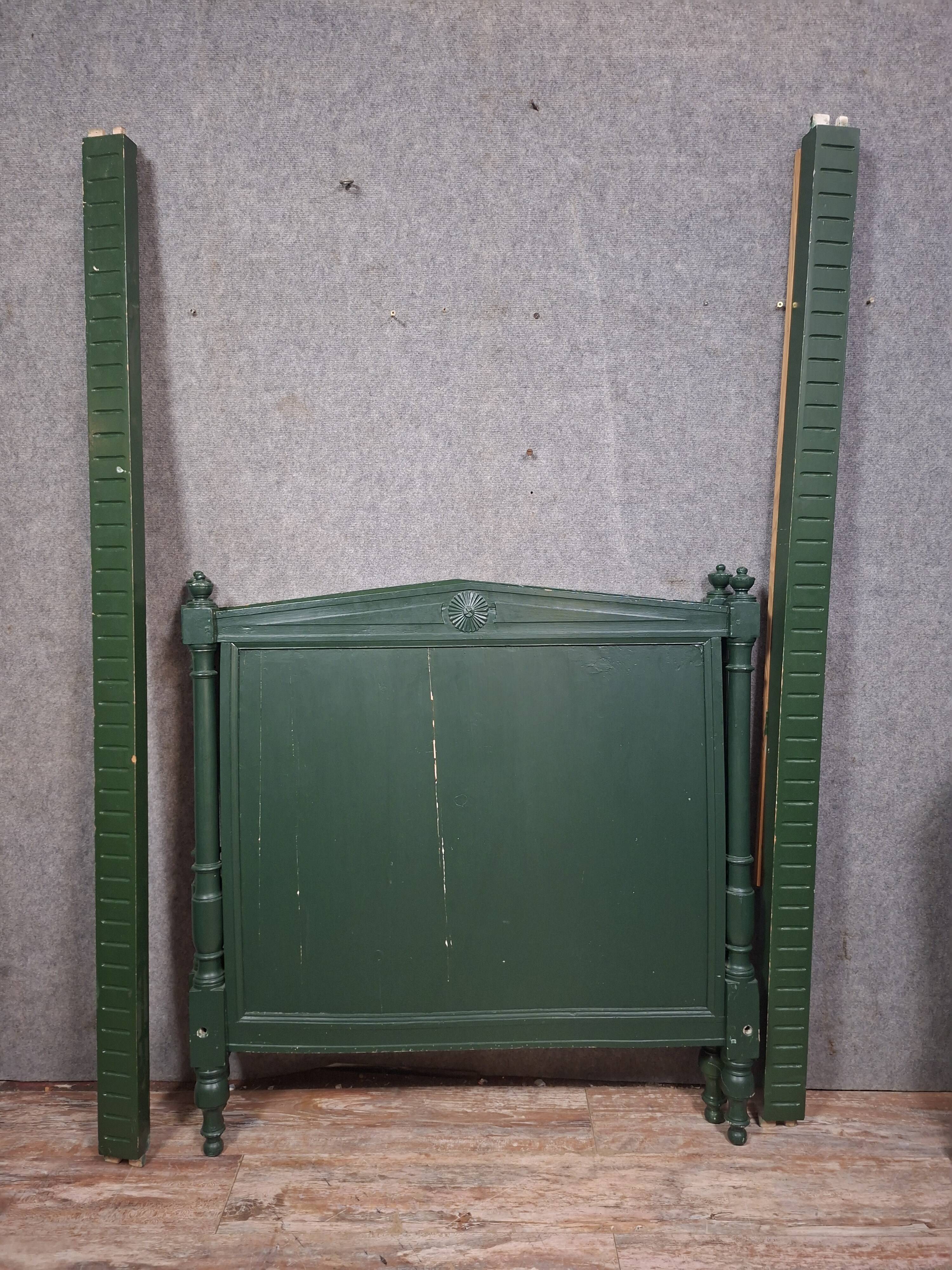 Directoire style bed in painted green wood.