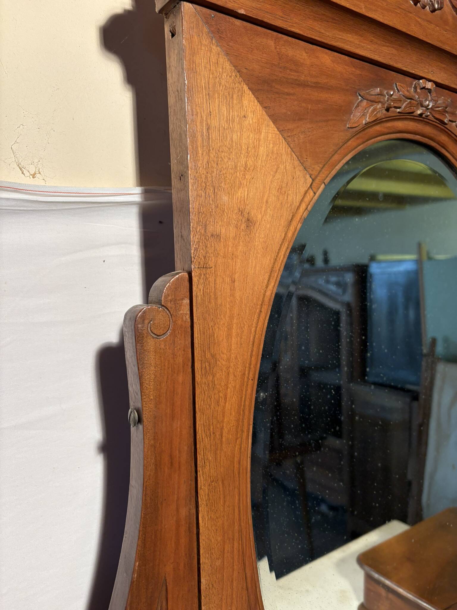 Antique carved wooden dressing table with marble and tilting oval mirror.