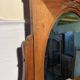 Antique carved wooden dressing table with marble and tilting oval mirror.