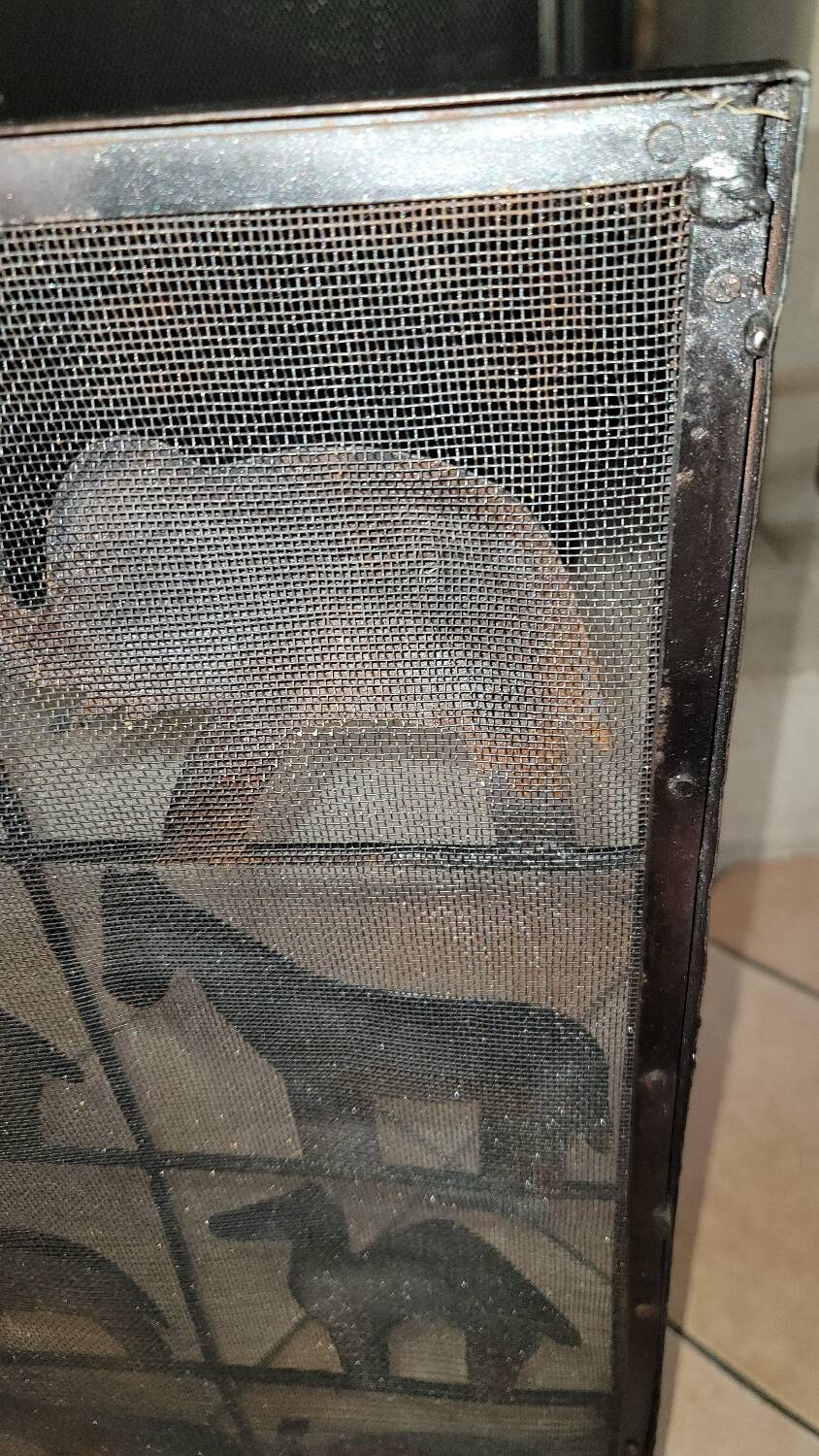 Black metal firewall decorated with animals