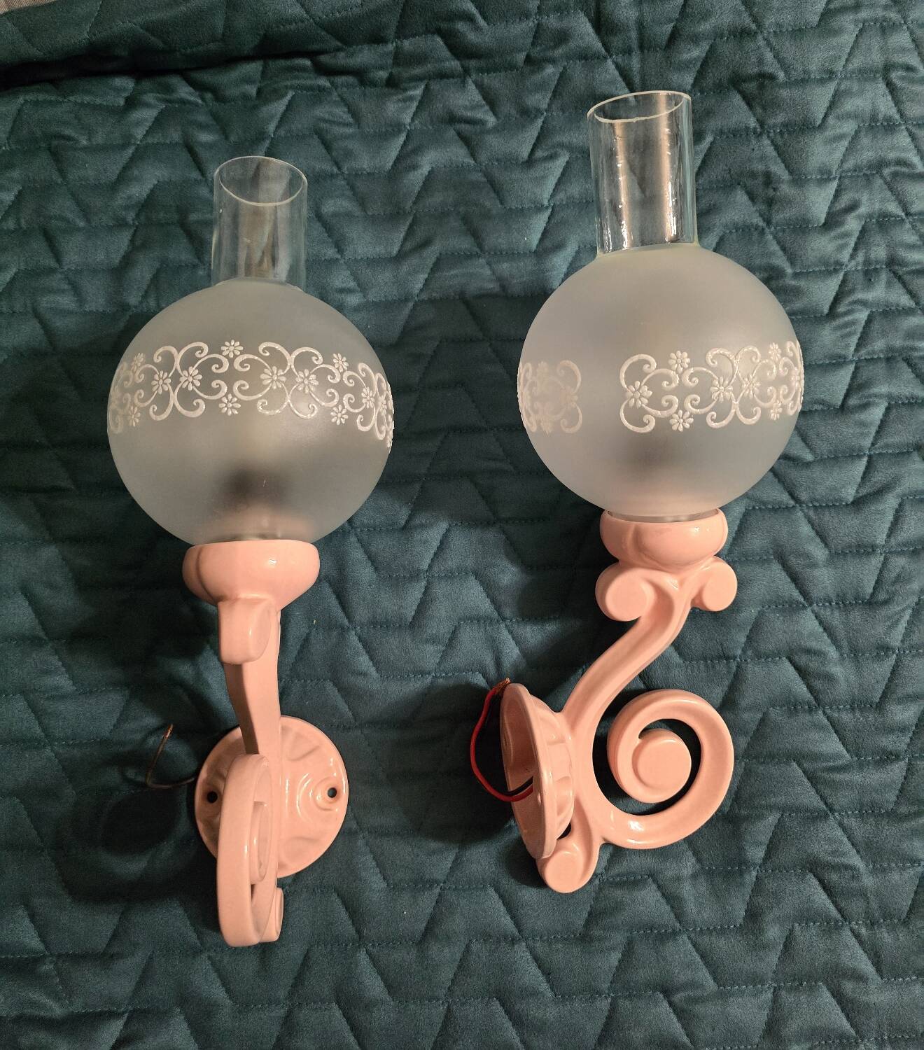 Original wall lights in pink enamelled cast iron with frosted glass globes.